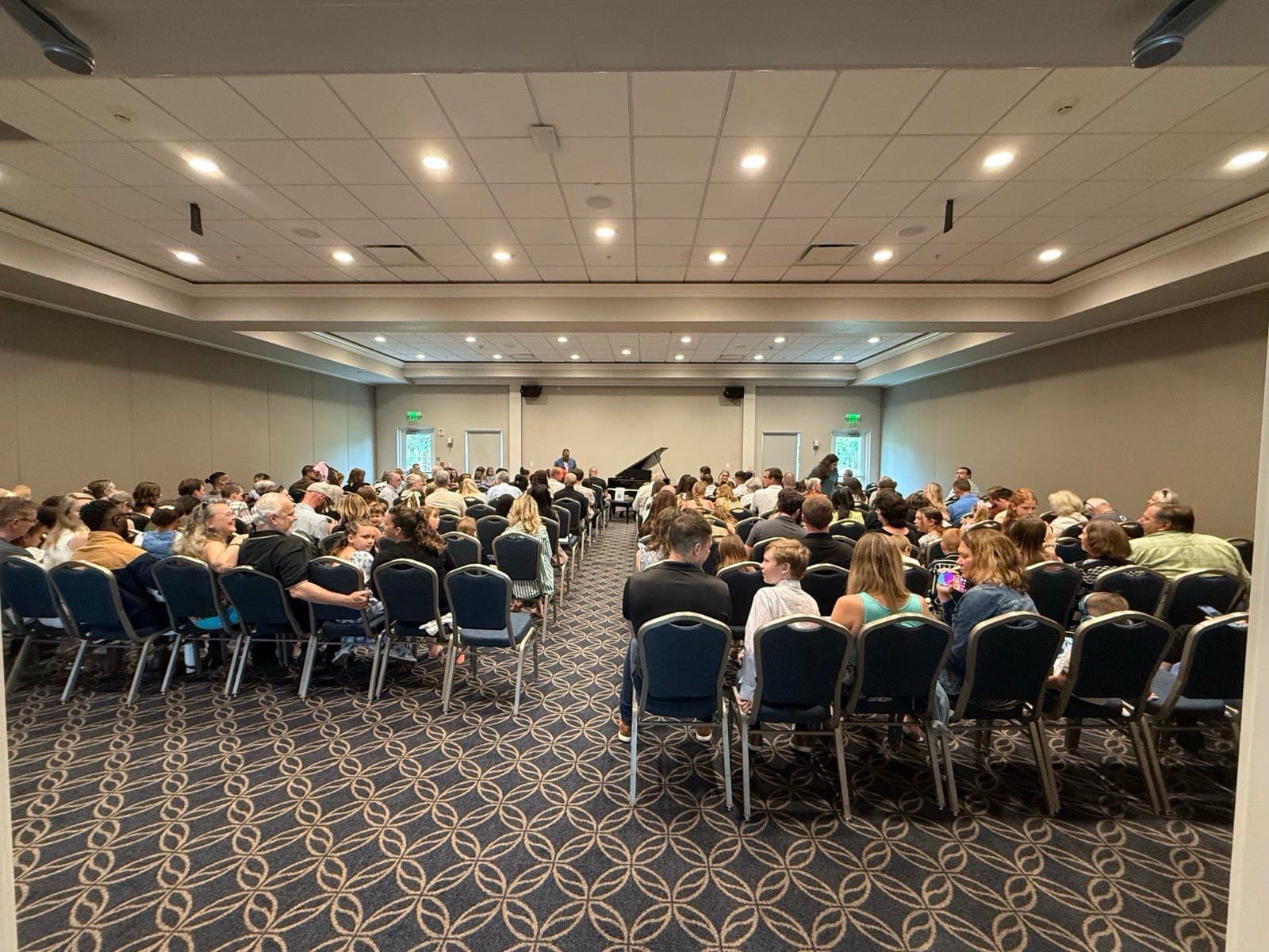 A packed audience of families watching the Lively Keys piano recital